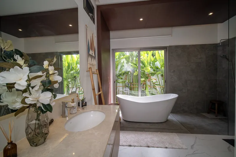 Bathroom with a freestanding bathtub overlooking the tropical garden
