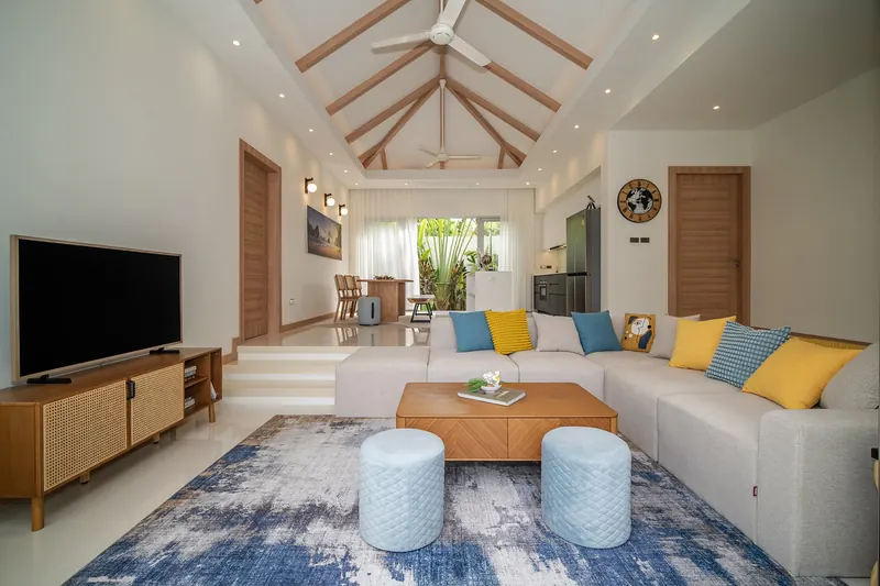 Living room with a sunken sofa area under a vaulted timber ceiling